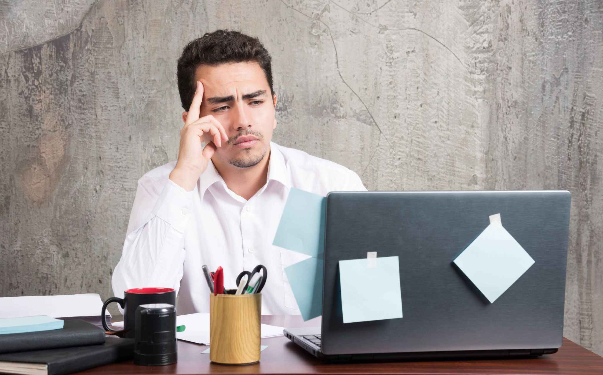 Manager reviewing absence patterns and HR records on a laptop
