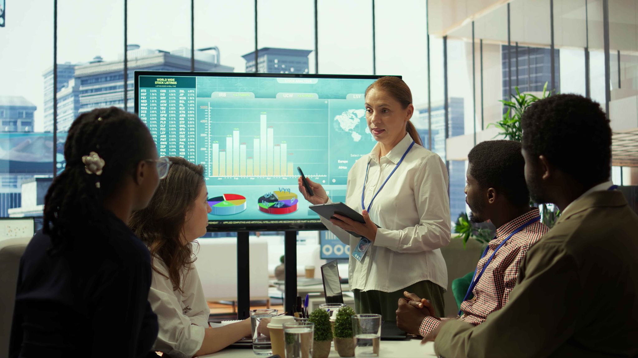 Team discussing workforce forecasting data on a screen