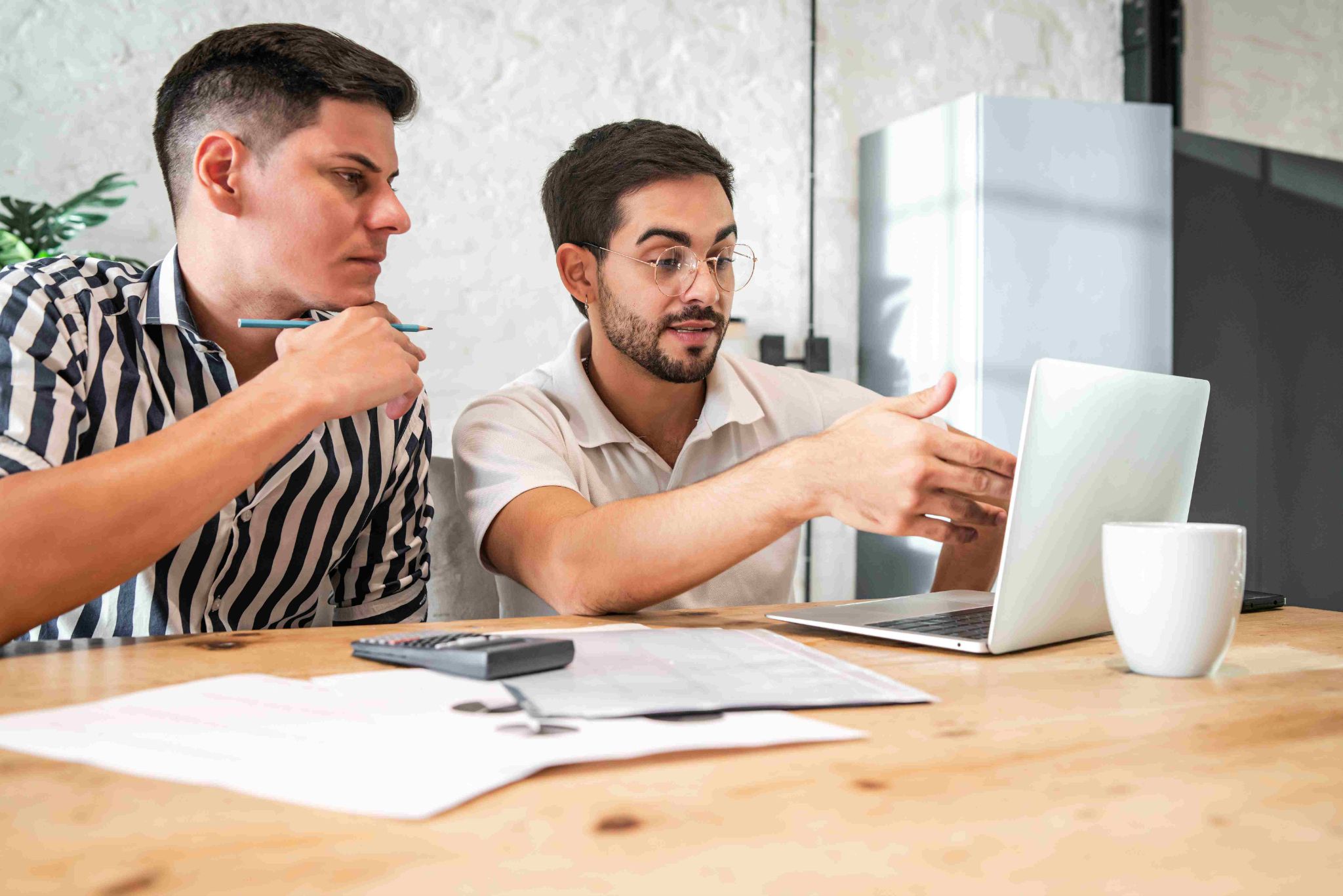 Colleagues discussing at desk