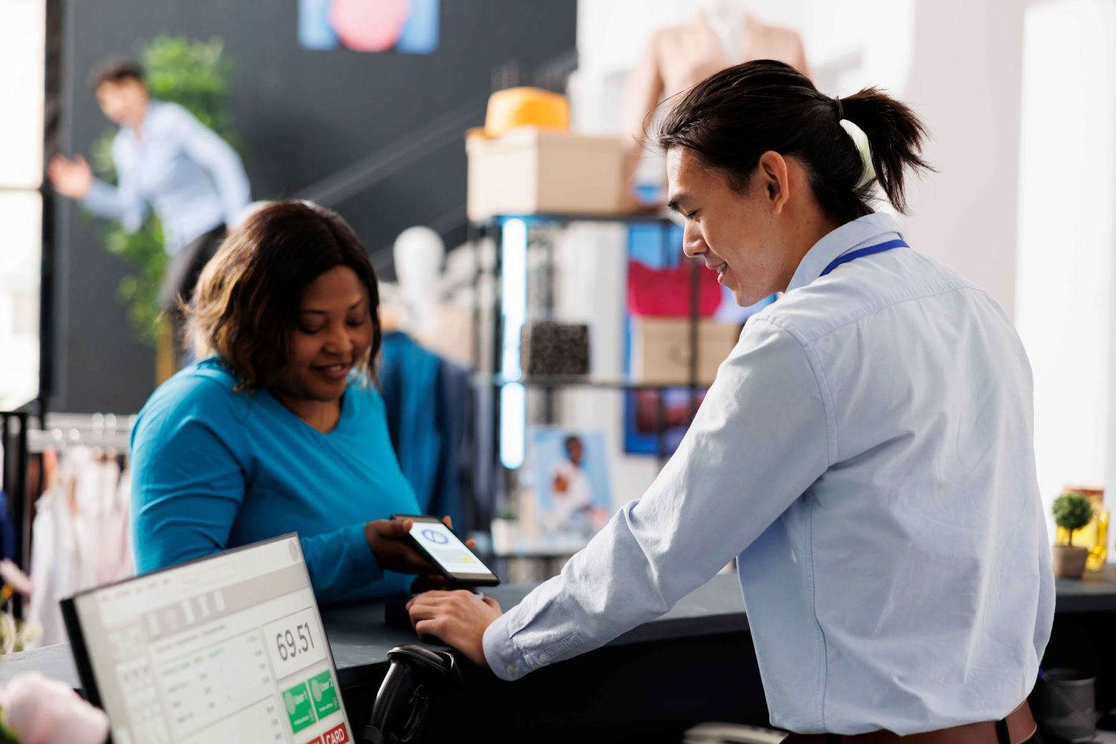 Retail staff using time tracking solutions at the counter