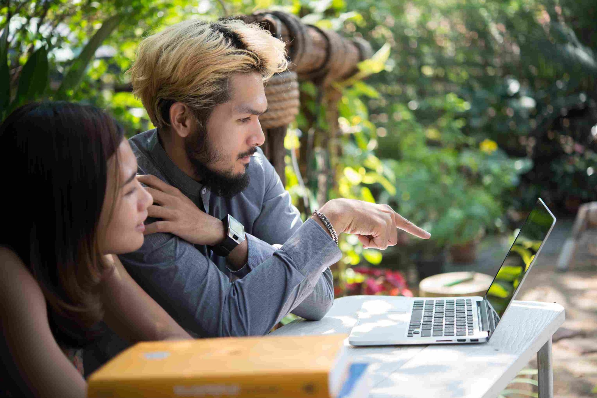 Team members looking at a laptop screen together