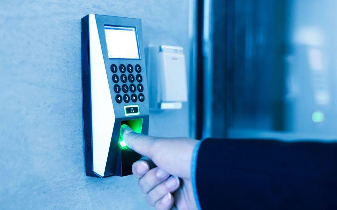 Person scanning fingerprint on a modern biometric device with blue lighting