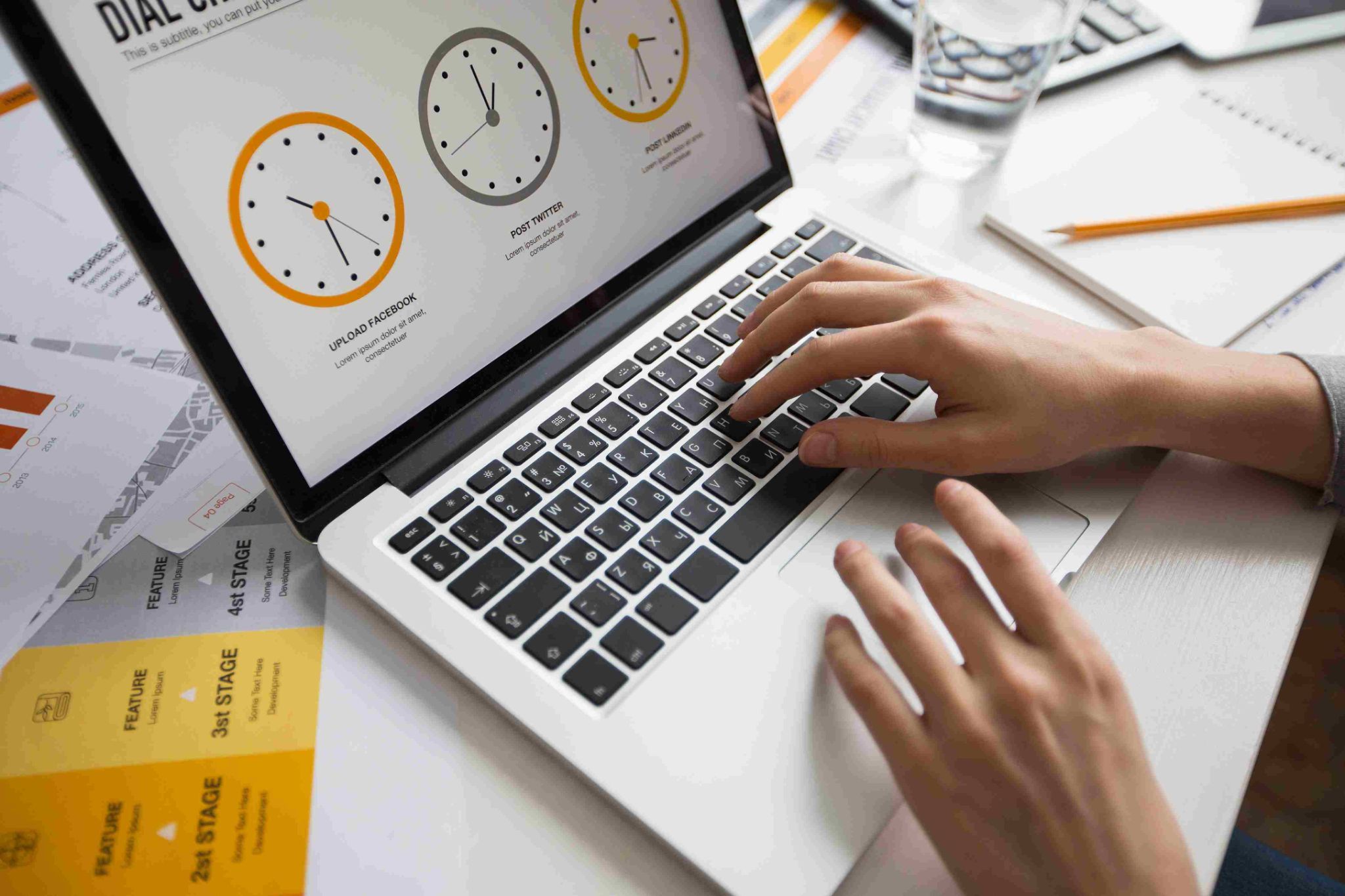 Hands typing on a laptop with time tracking graphics