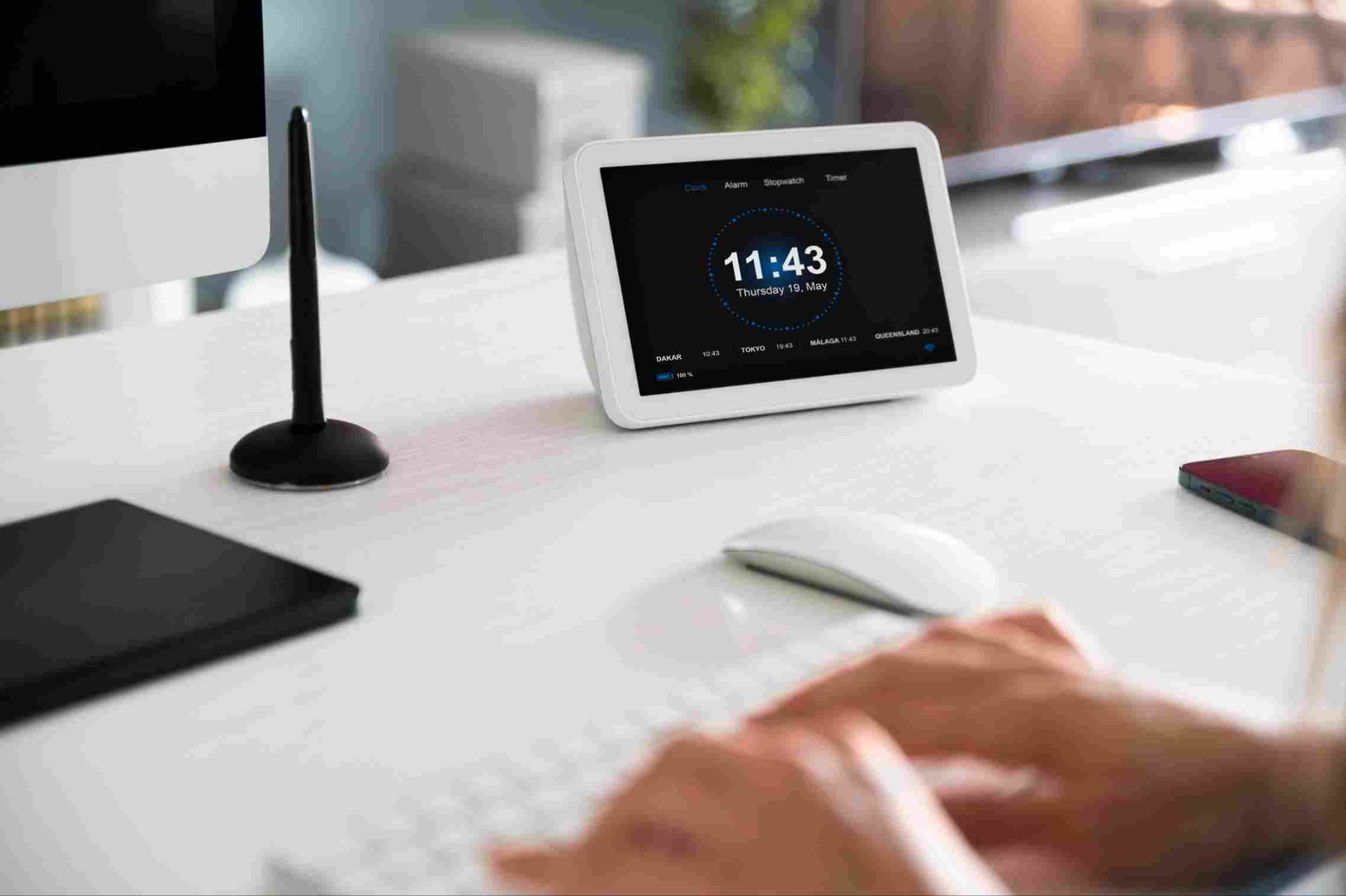 Tablet on a desk displaying the time