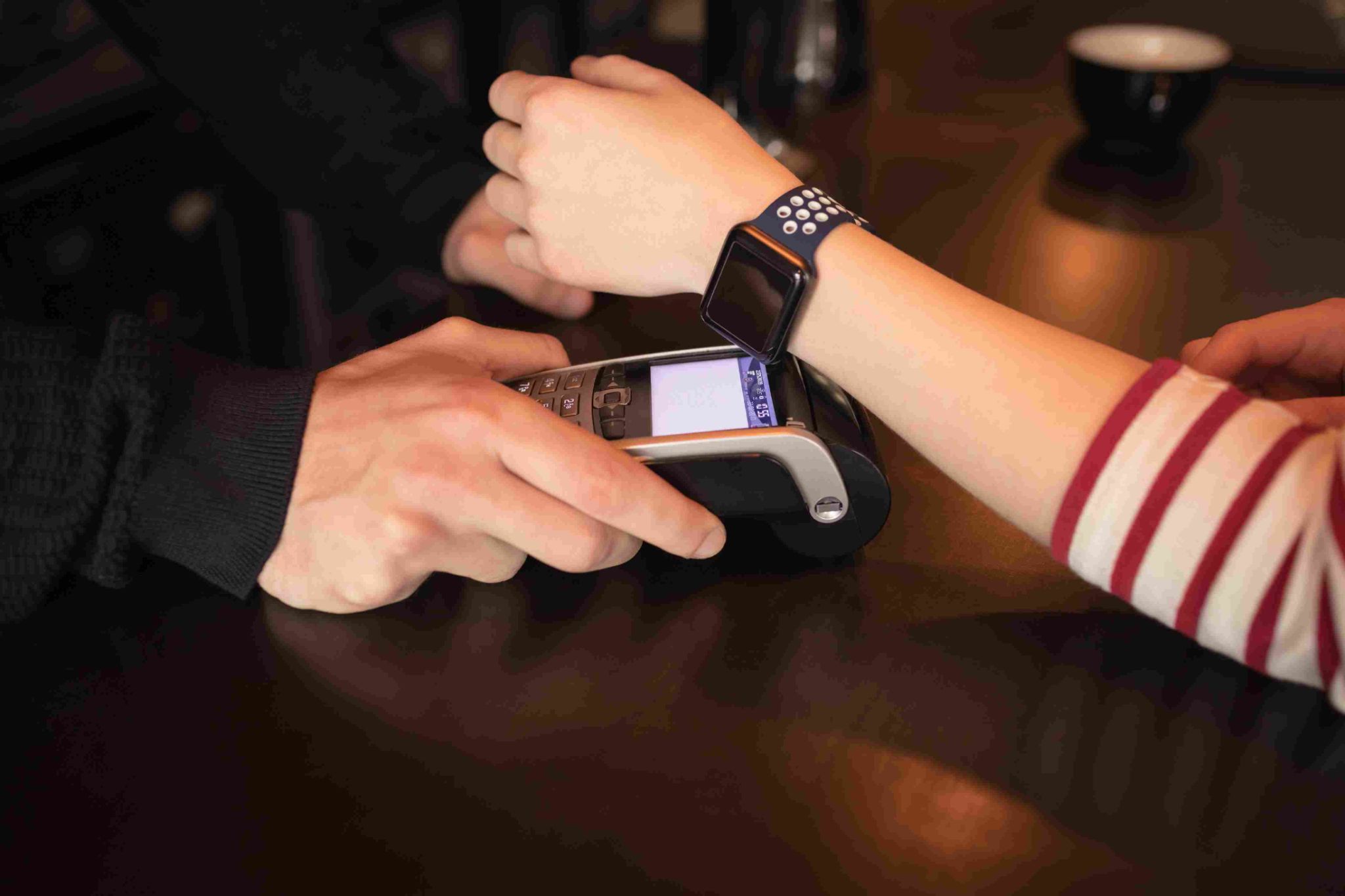 Employee clocking in using a smart watch and scanner device