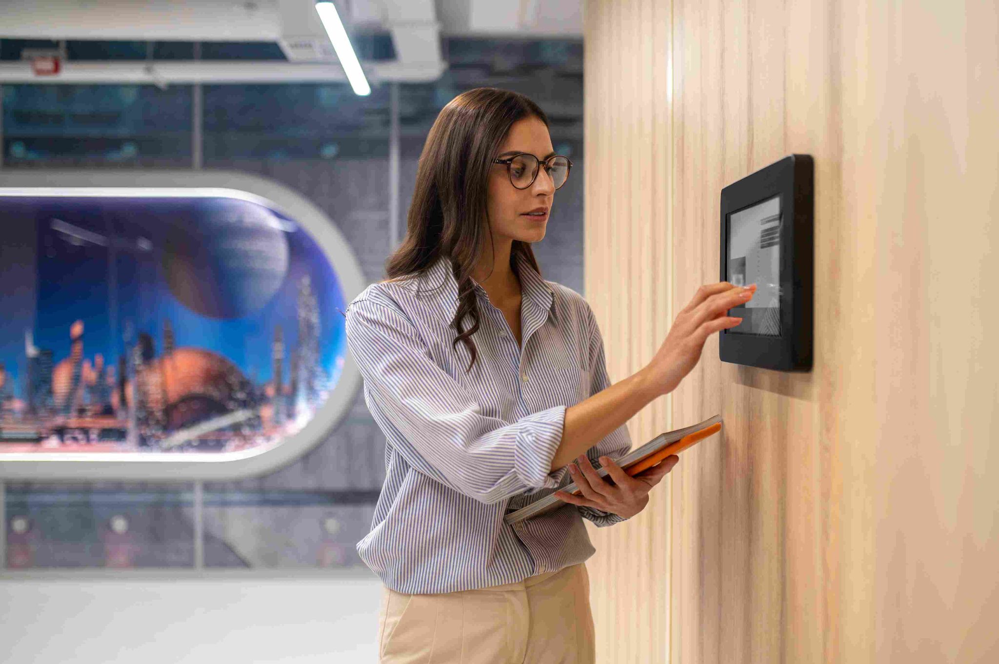 Woman using a tablet kiosk for facial recognition clock-in