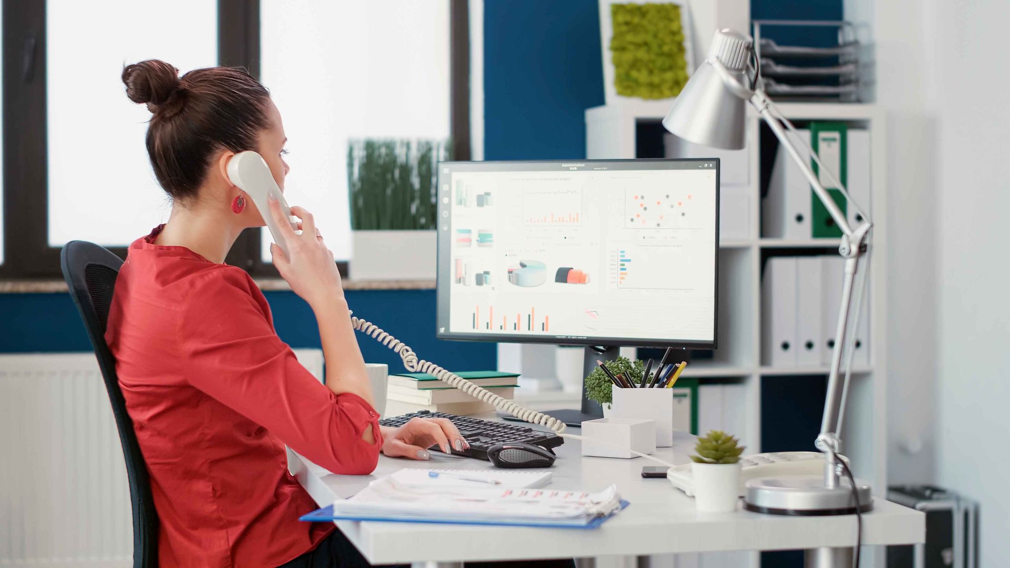 Woman working at desk on phone