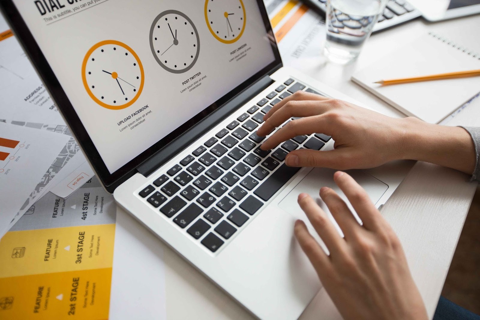 Person typing on a laptop with time tracking charts