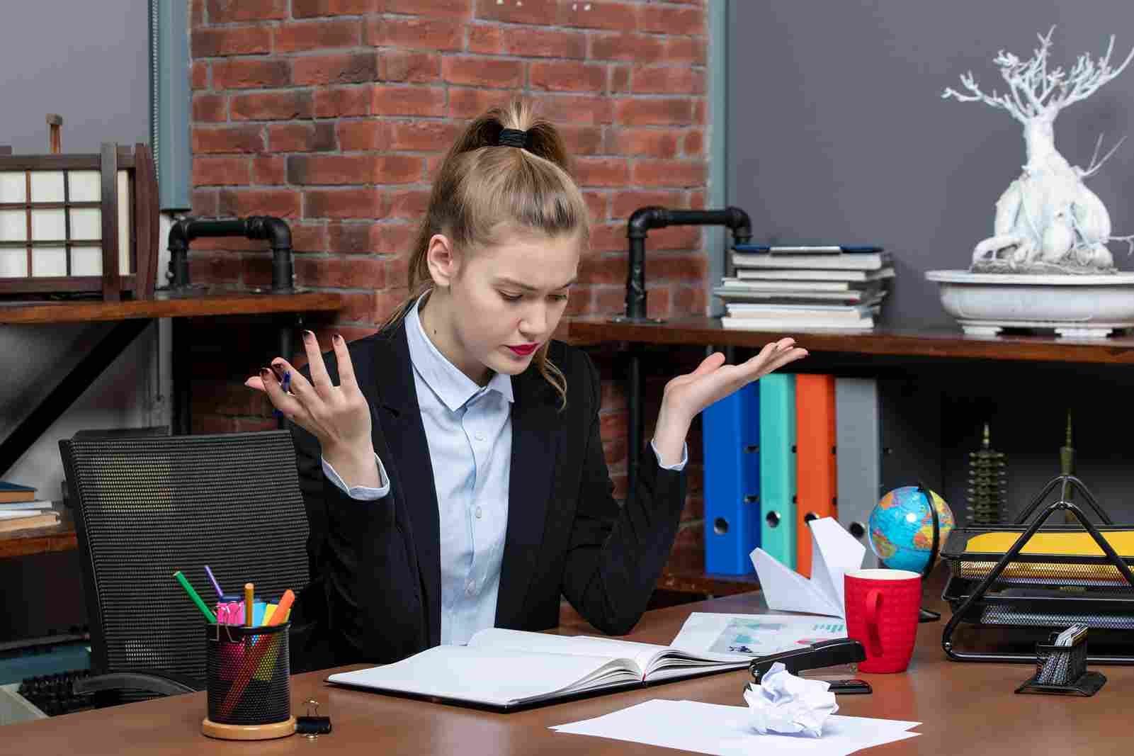 Woman looking frustrated with paperwork