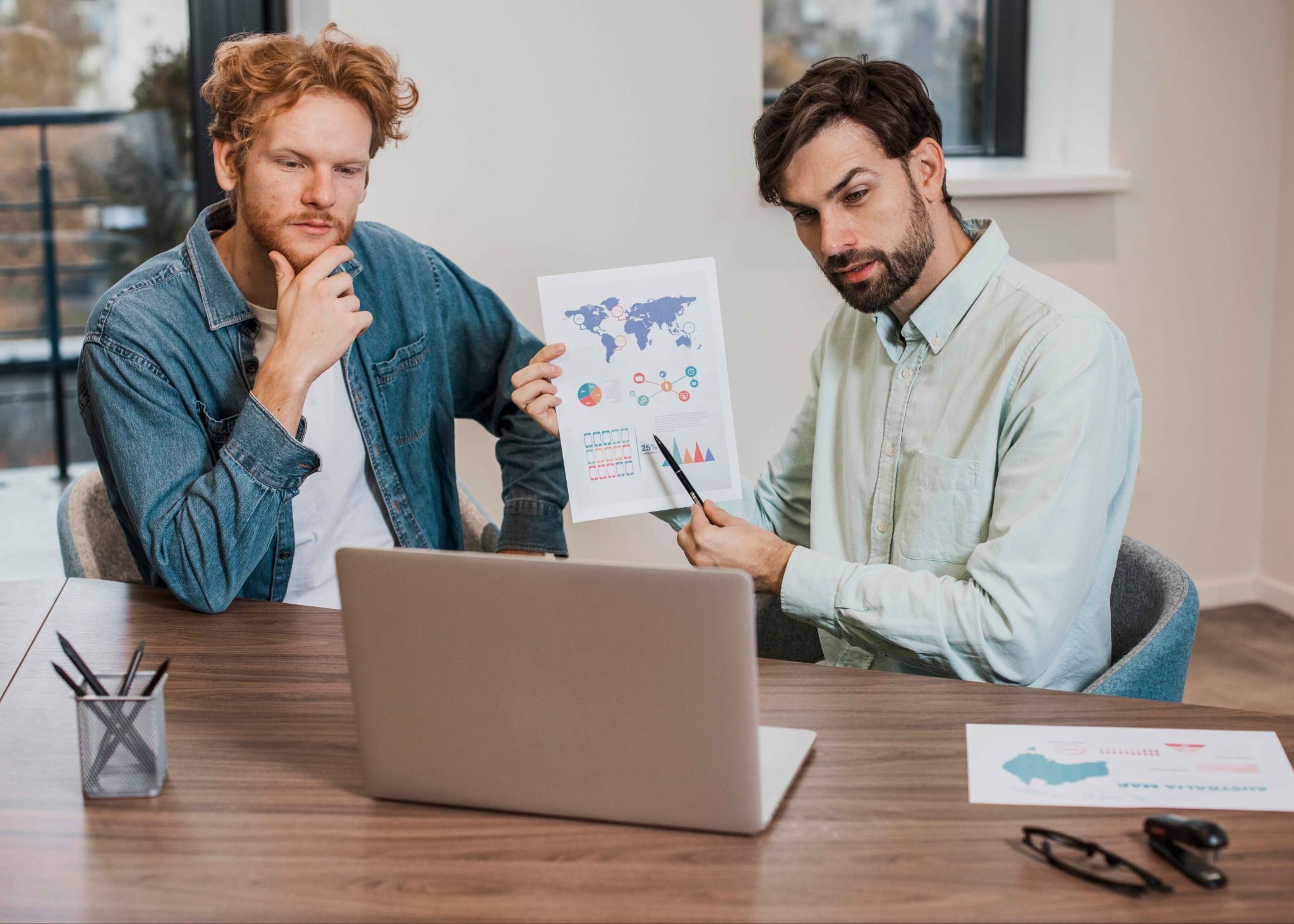 Two men analyzing reports and pricing