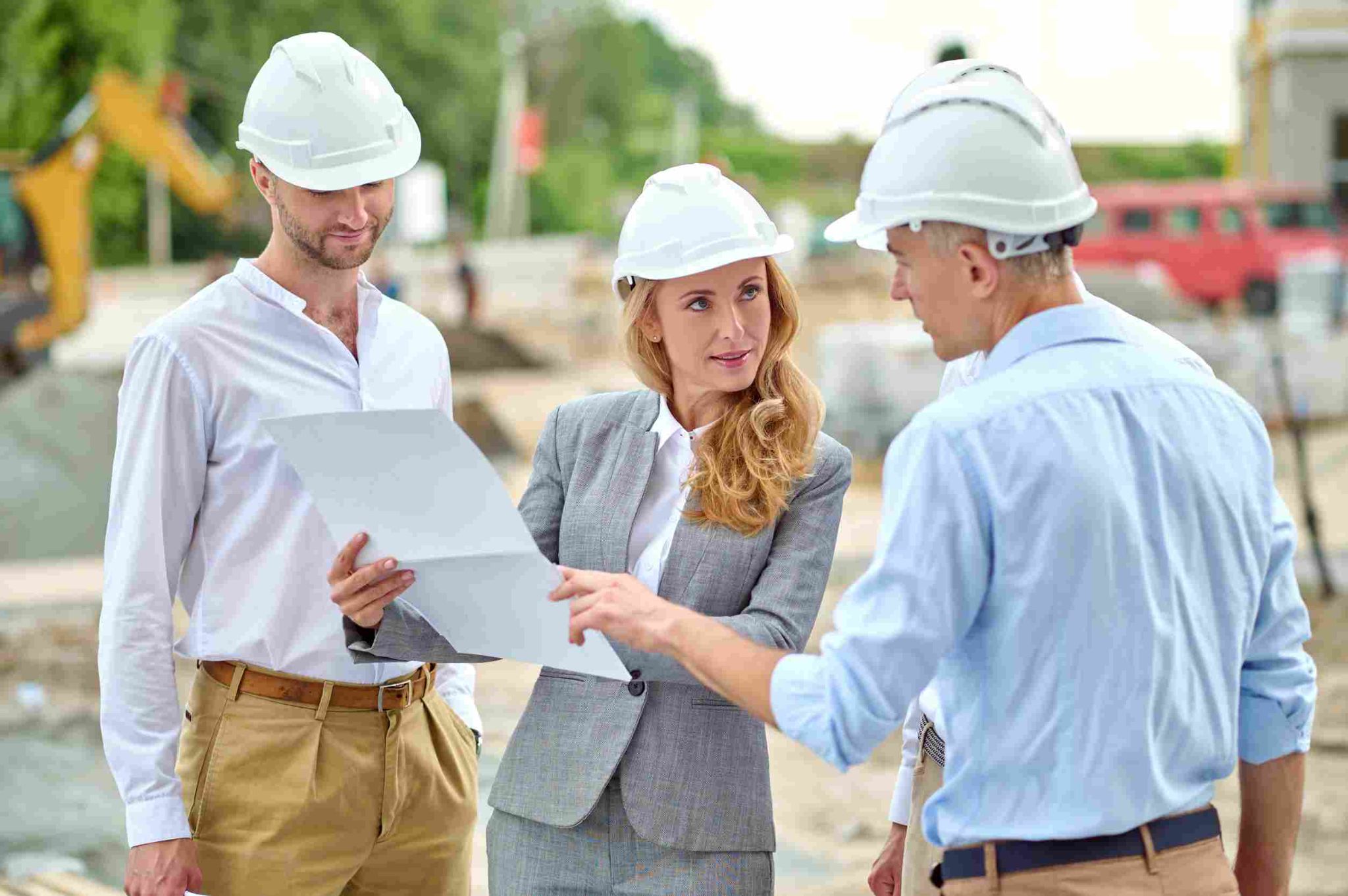 Construction workers and supervisor discussing plans on site