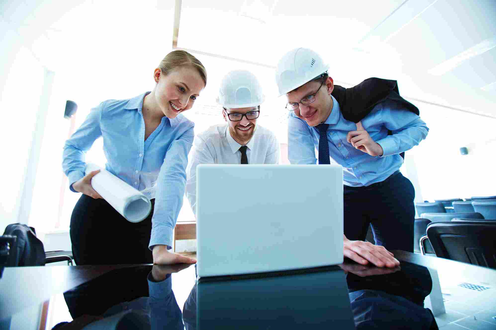 Construction team reviewing plans on a laptop
