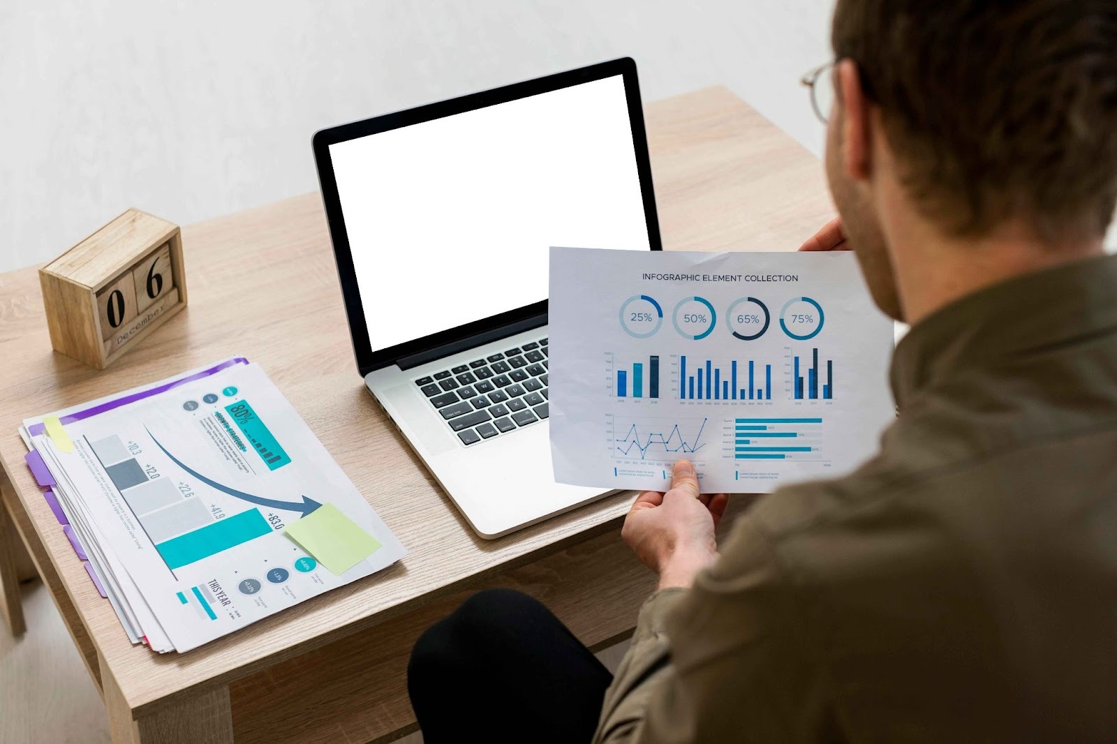 People reviewing charts and laptop