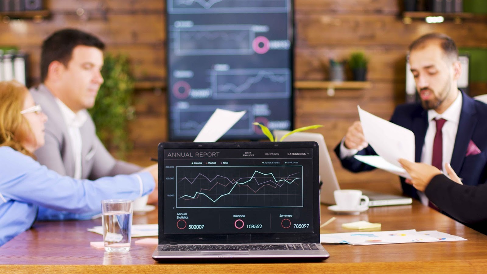 Business professionals analyzing data on a laptop