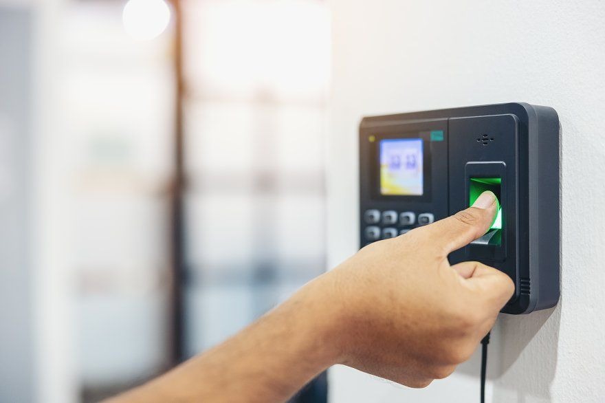Close-up of a finger scanning on a biometric time clock