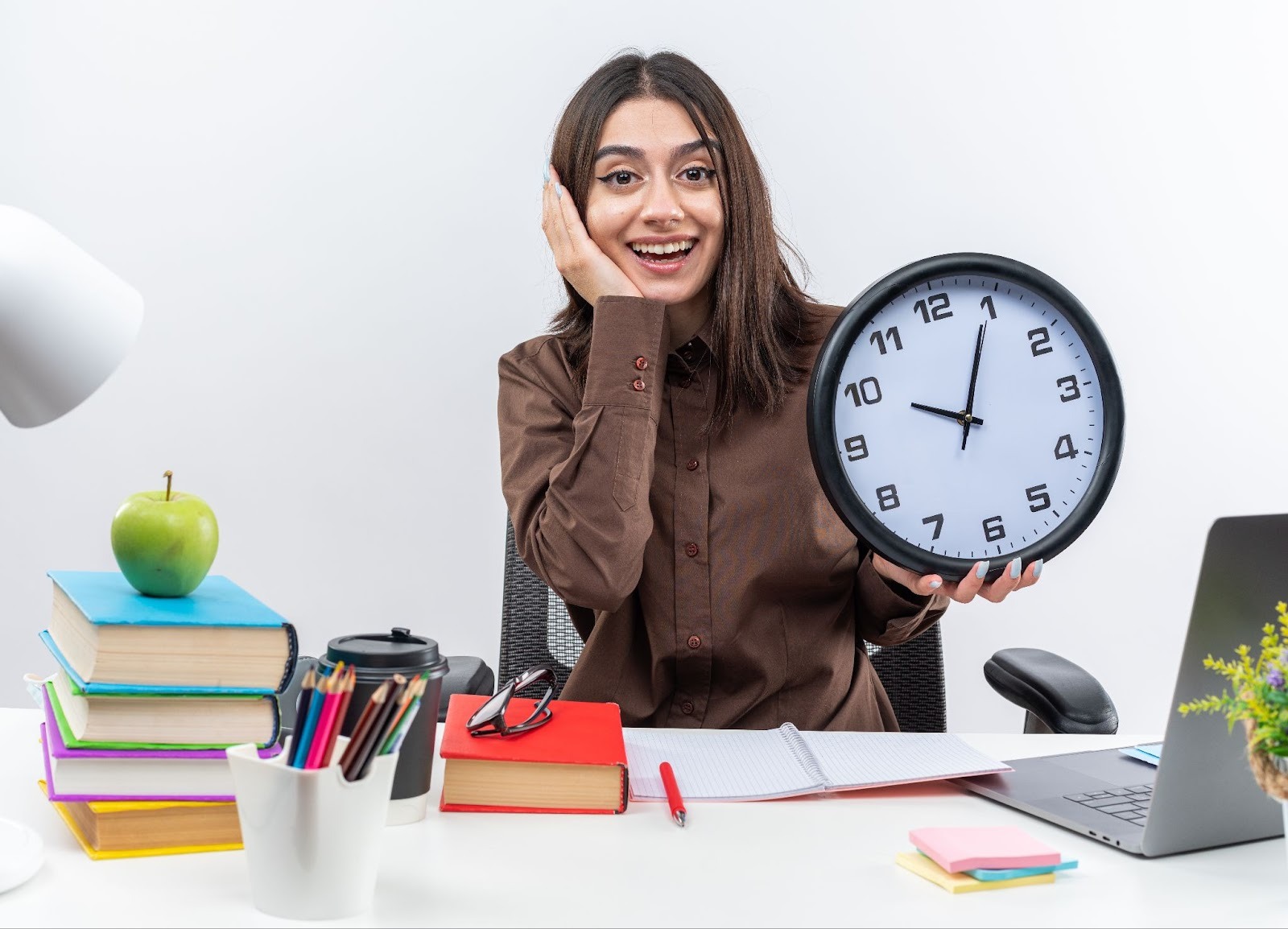 Woman smiling and leaning on a clock