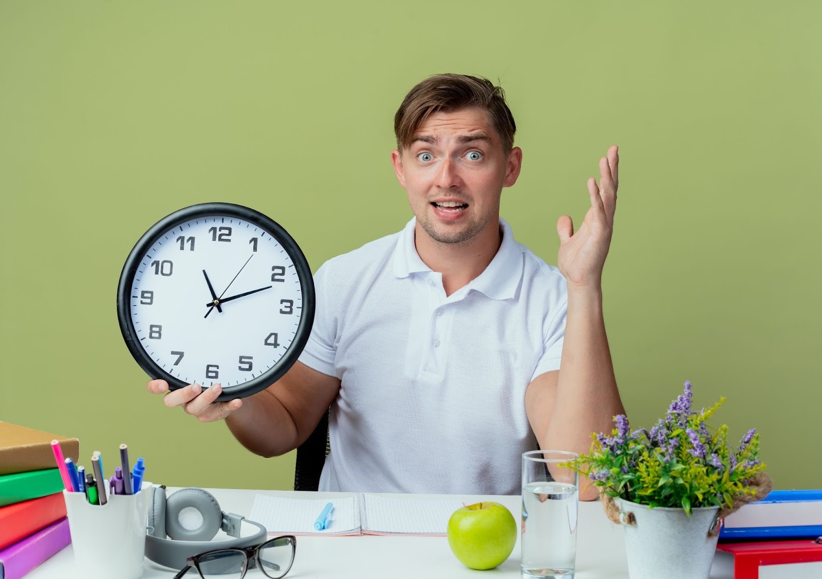 Man holding a clock looking confused
