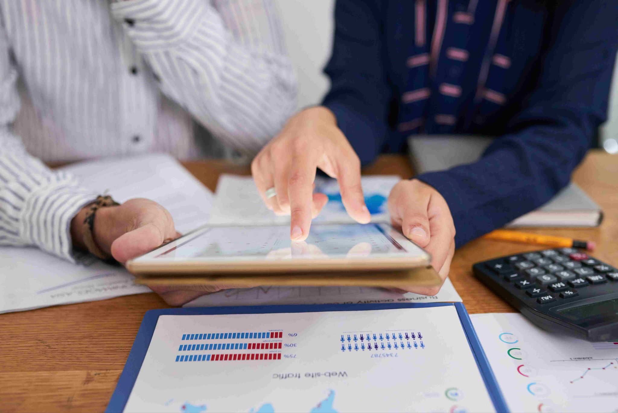 People looking at tablet and charts