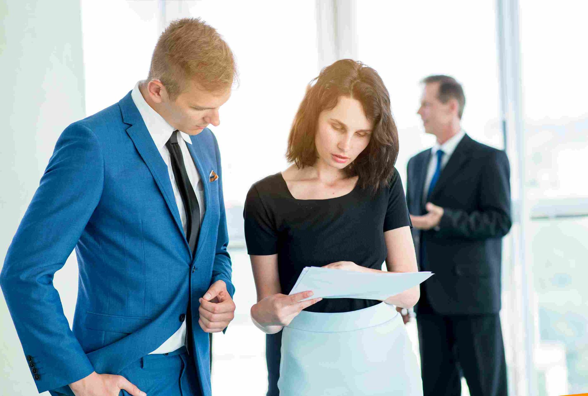 Business people reviewing attendance documentation