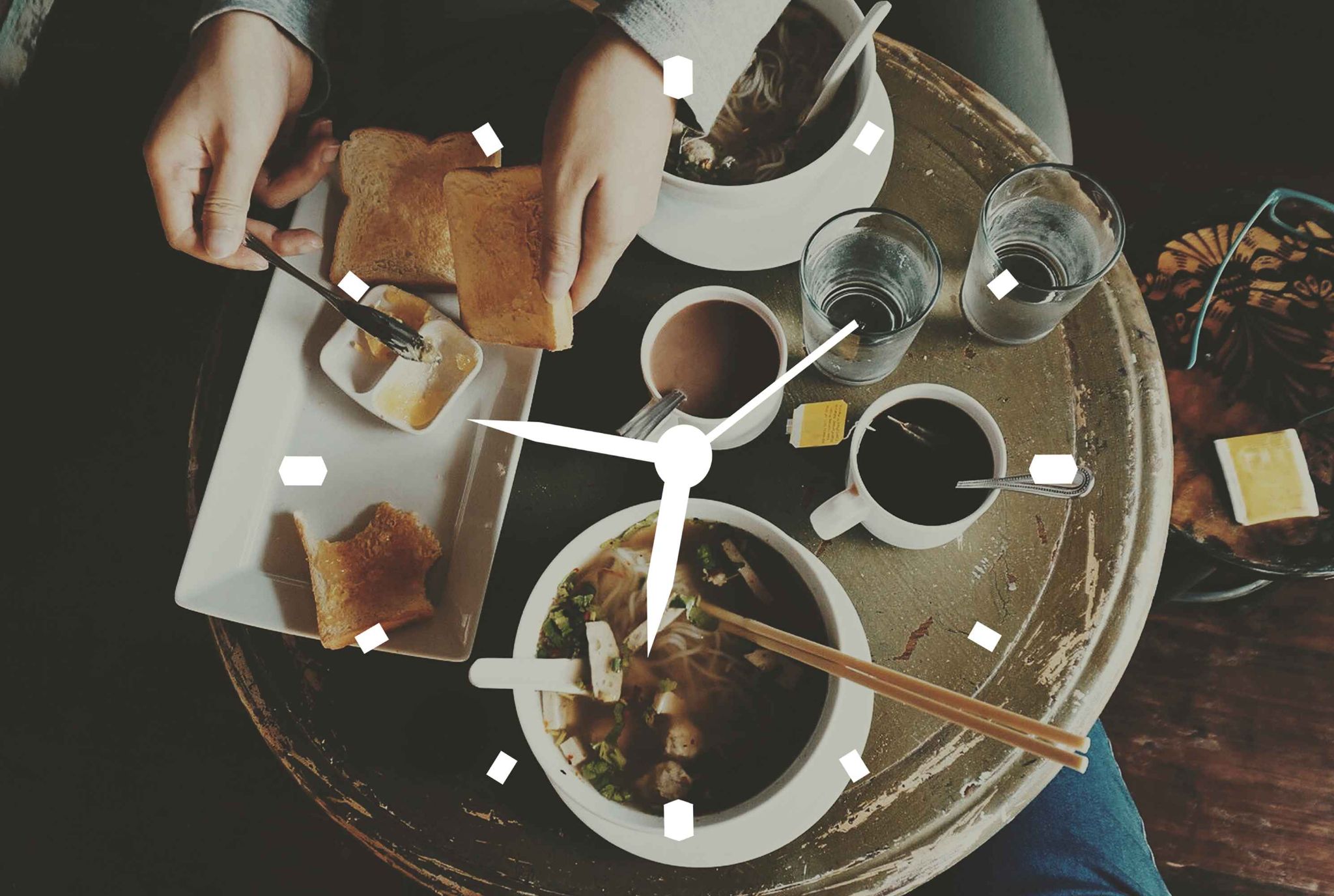 Clock on a table with breakfast