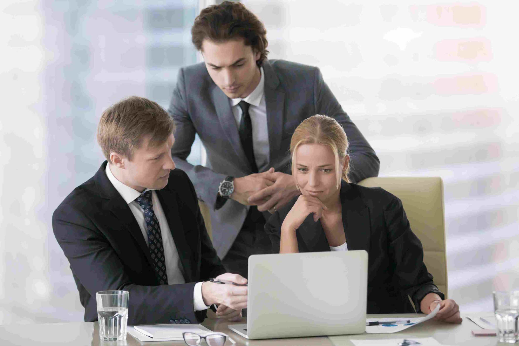 Business professionals reviewing time tracking compliance
