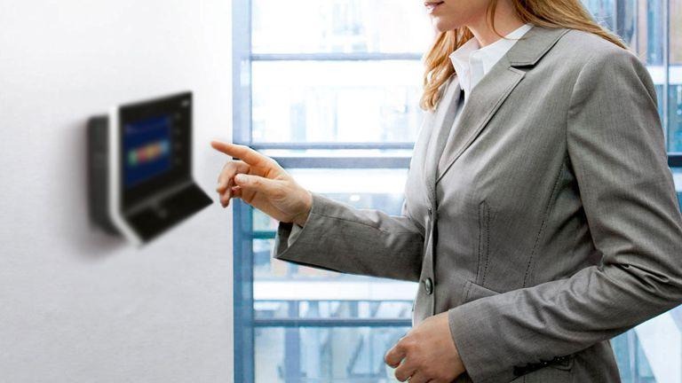 Woman using a wall-mounted time clock terminal