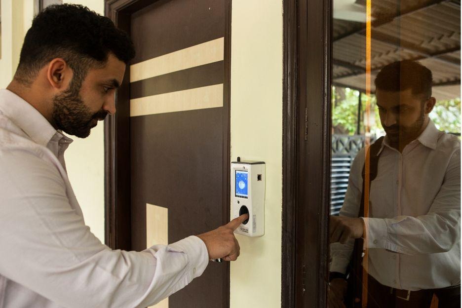 Man using a fingerprint time clock scanner