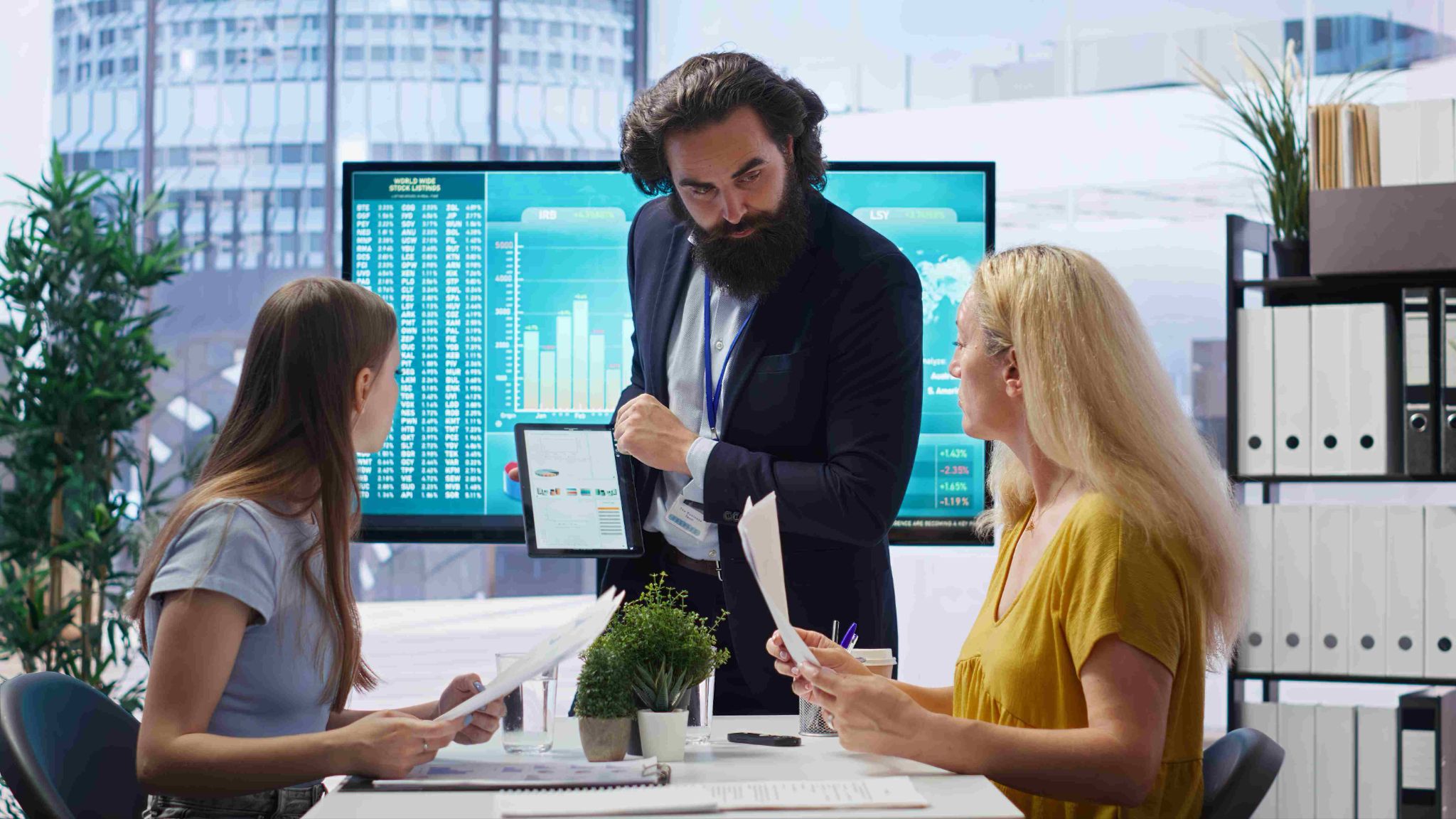 Team analyzing utilization data on a large monitor