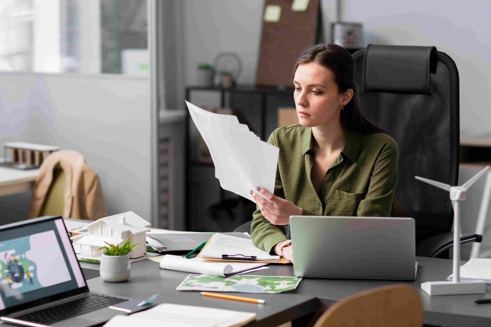 Woman working at desk reviewing documents