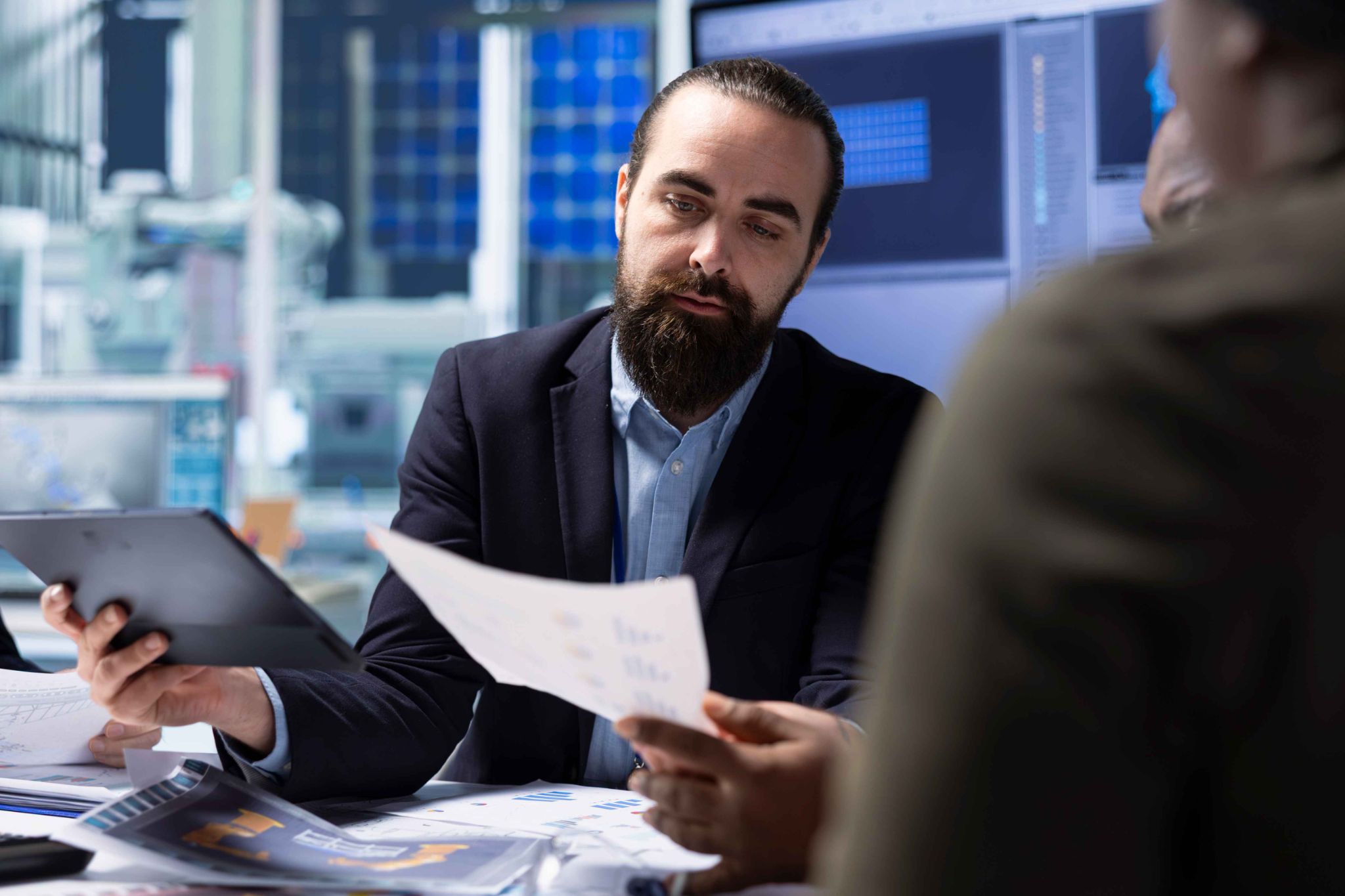 Two men in a meeting looking at documents