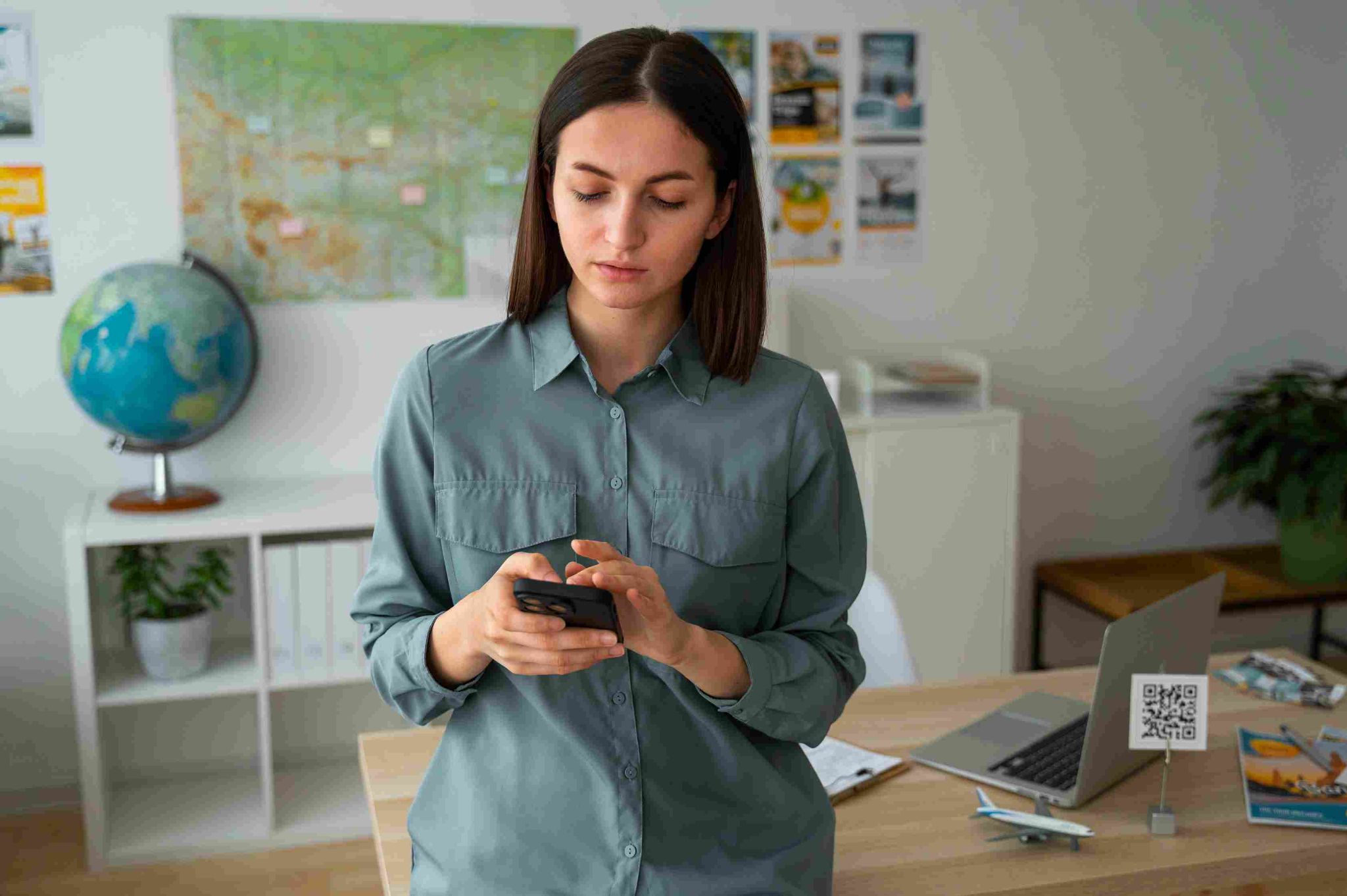 Woman standing and using a mobile phone
