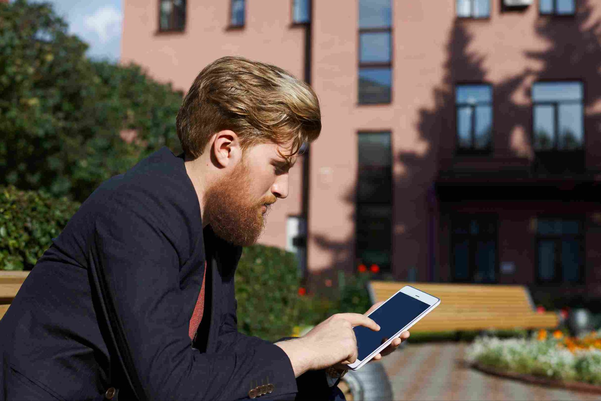 Man looking at his smartphone outdoors