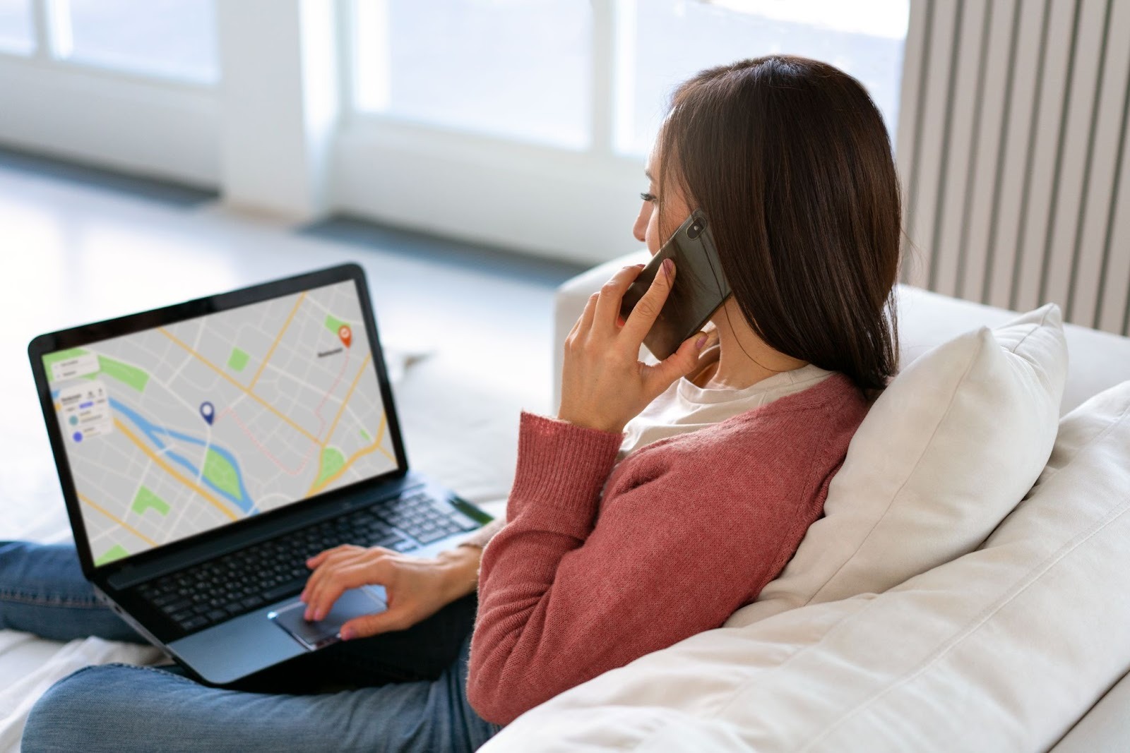 Person using laptop with a map for GPS tracking