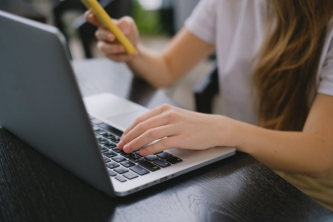 Person typing on a laptop keyboard