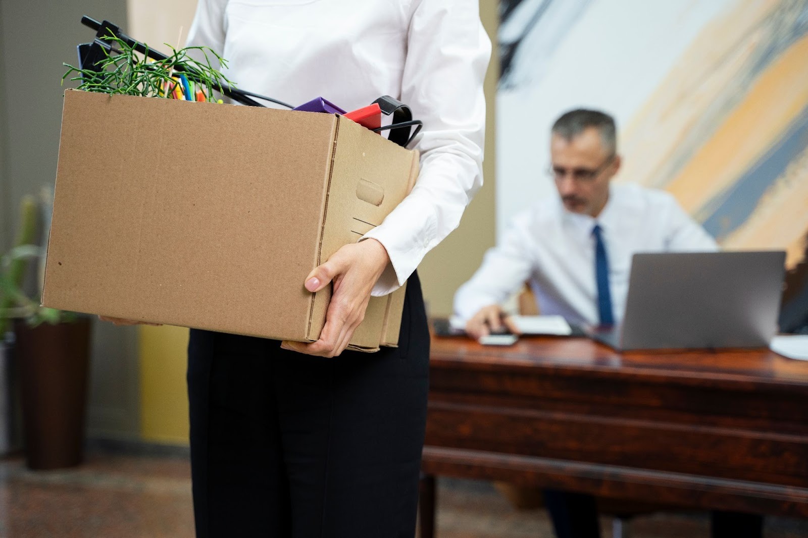 Employee carrying a box after termination