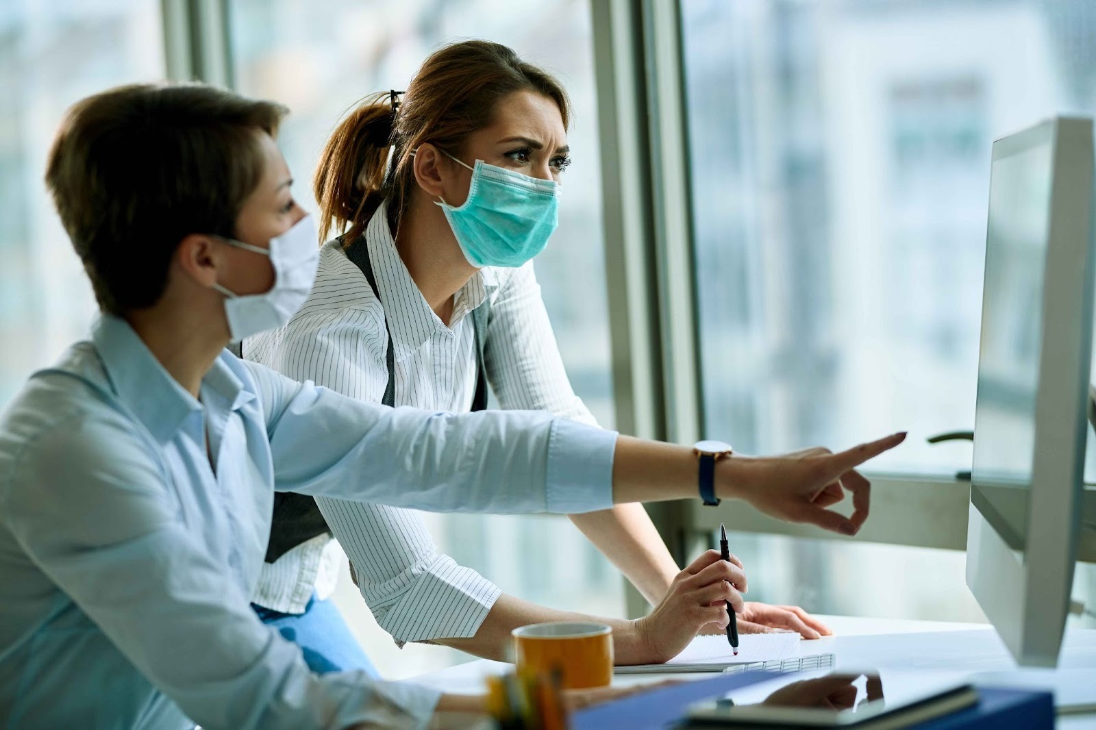 Healthcare professionals looking at a computer monitor