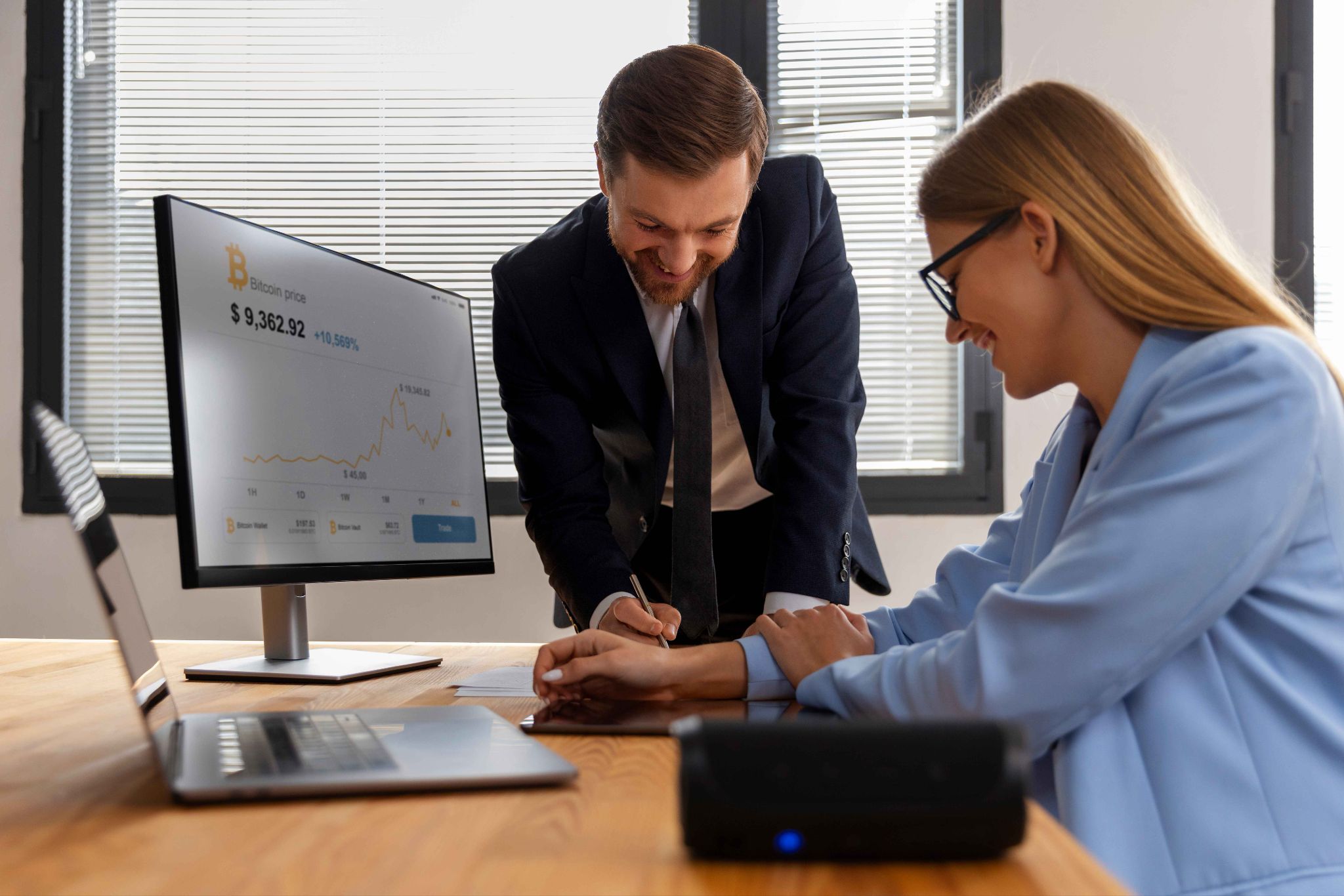 Employees using a self-service HR portal on a computer