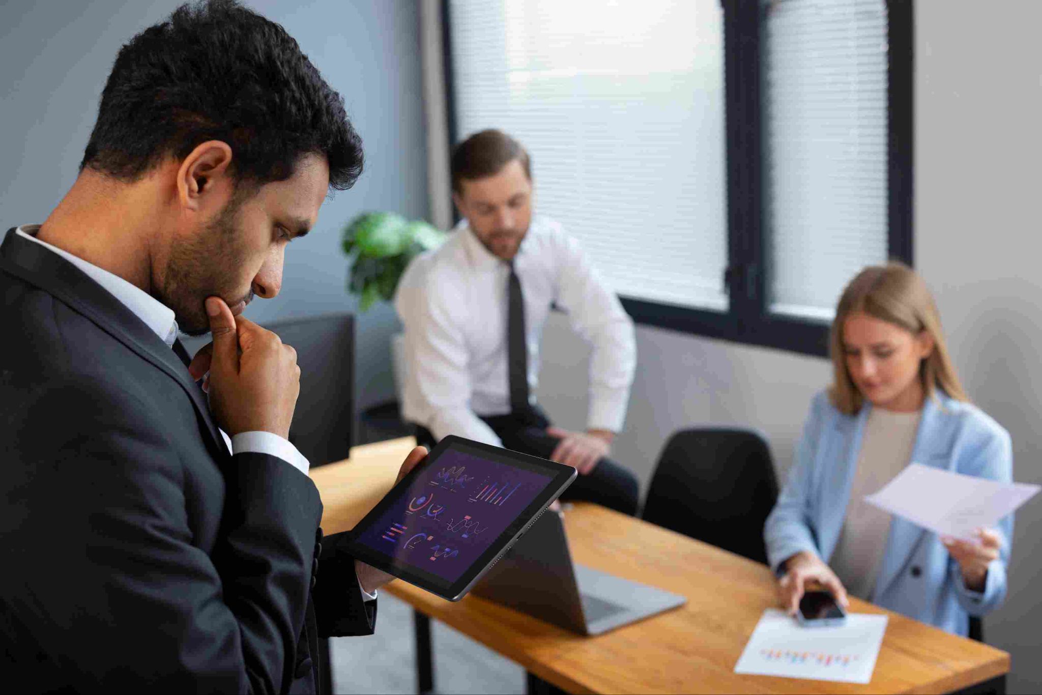 Business professionals looking at a tablet