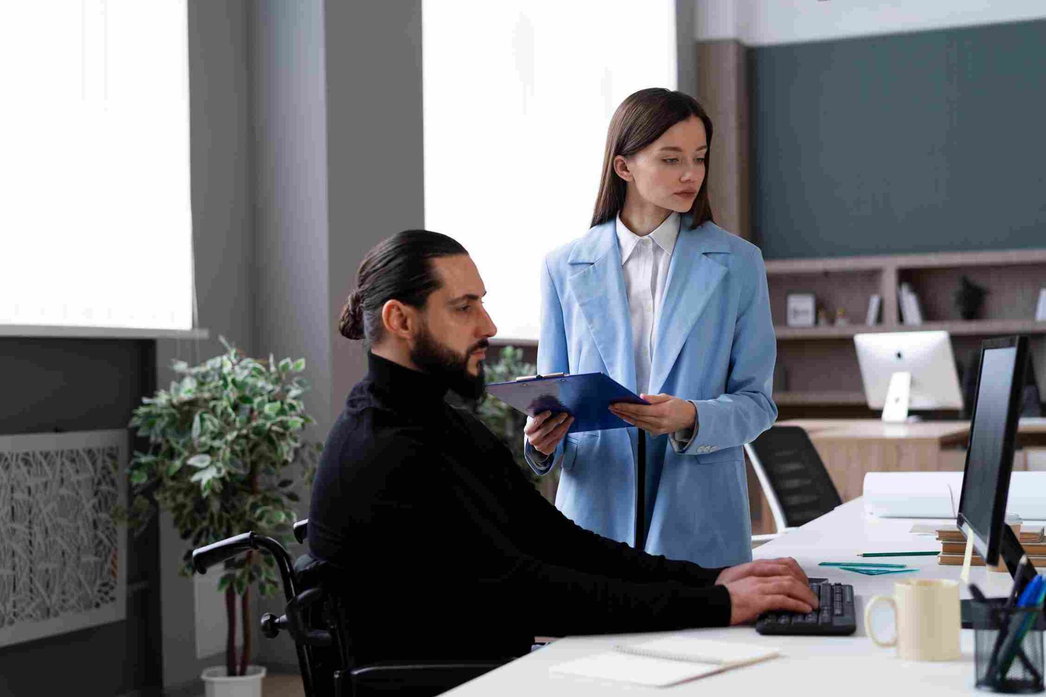 Employees using a computer for attendance tracking