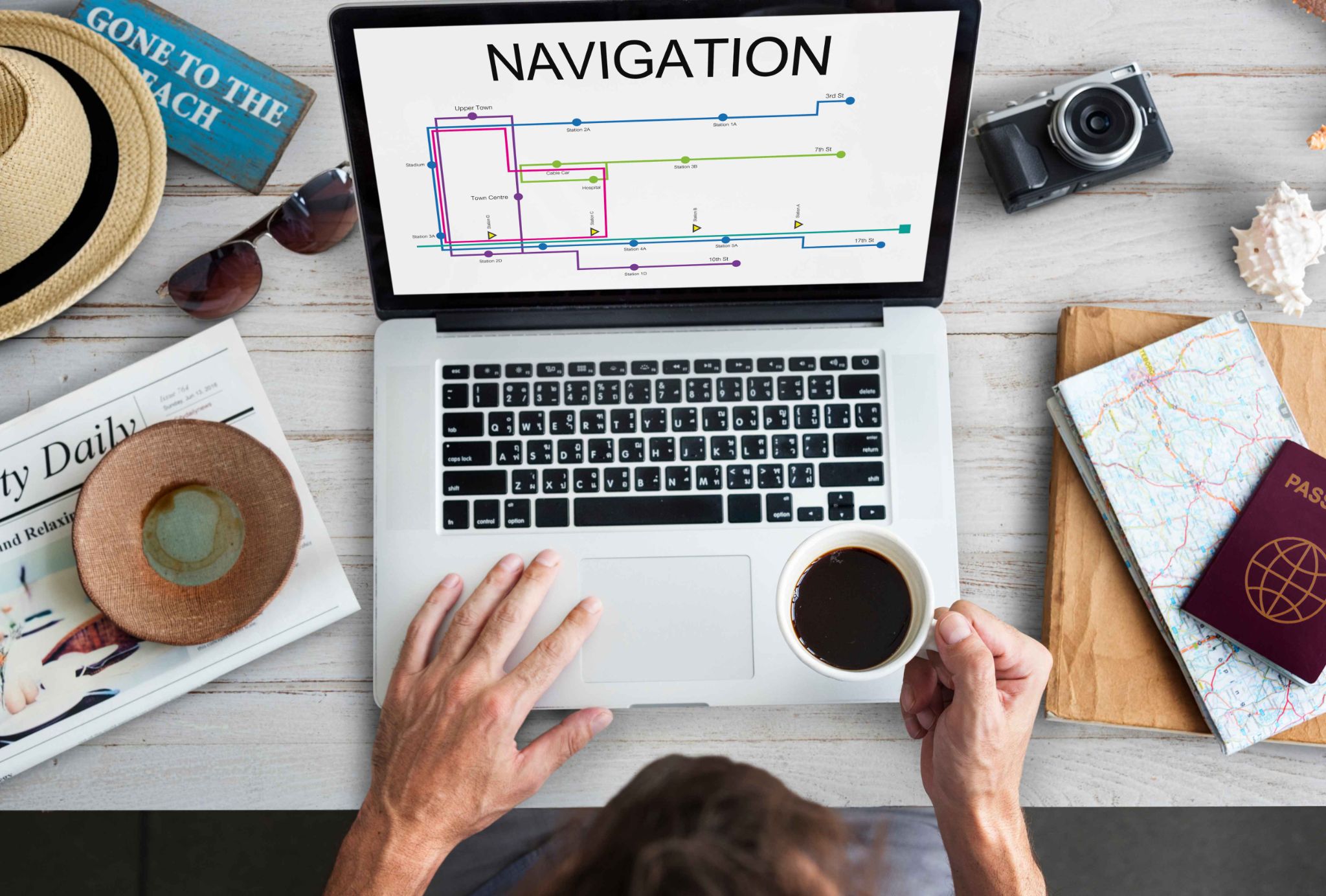 Person using laptop with navigation map