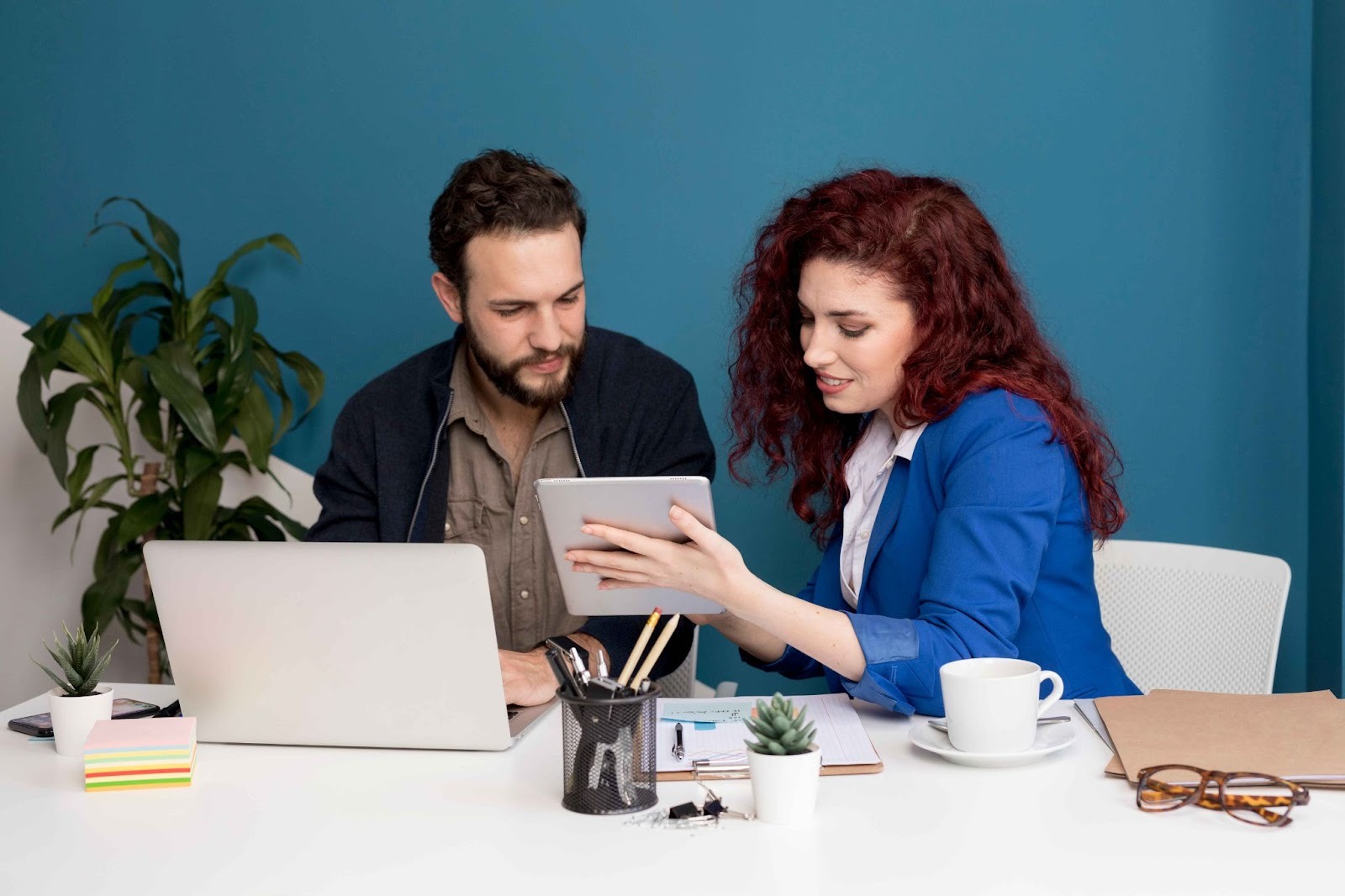 Manager and employee looking at a tablet