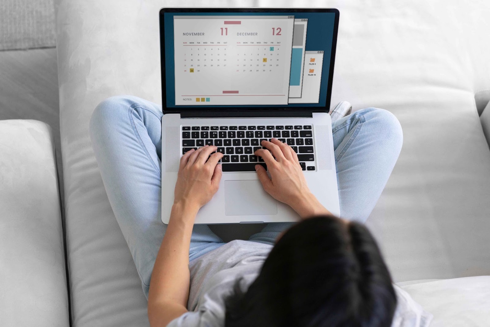 Person using a laptop for schedule planning