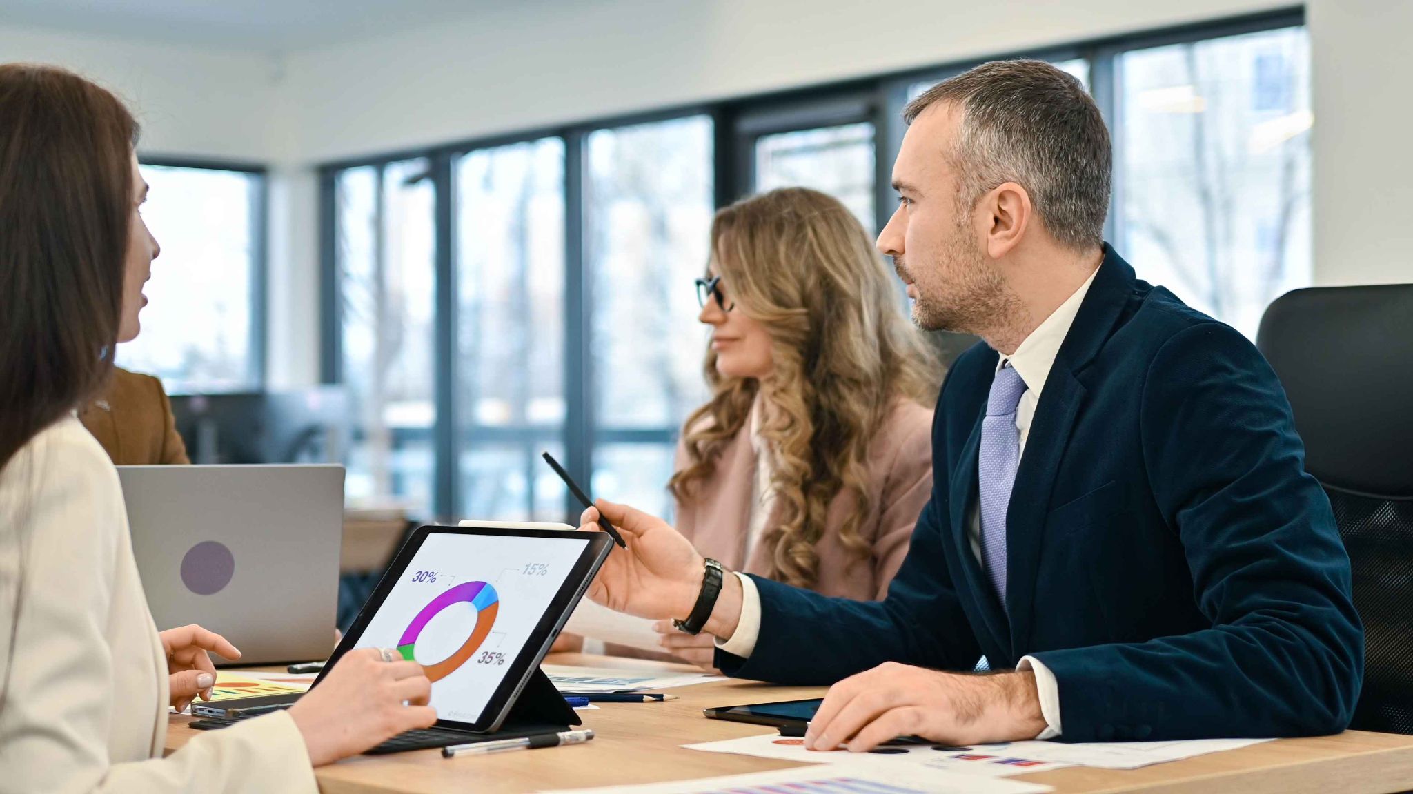 HR professionals reviewing charts and graphs for retention analytics