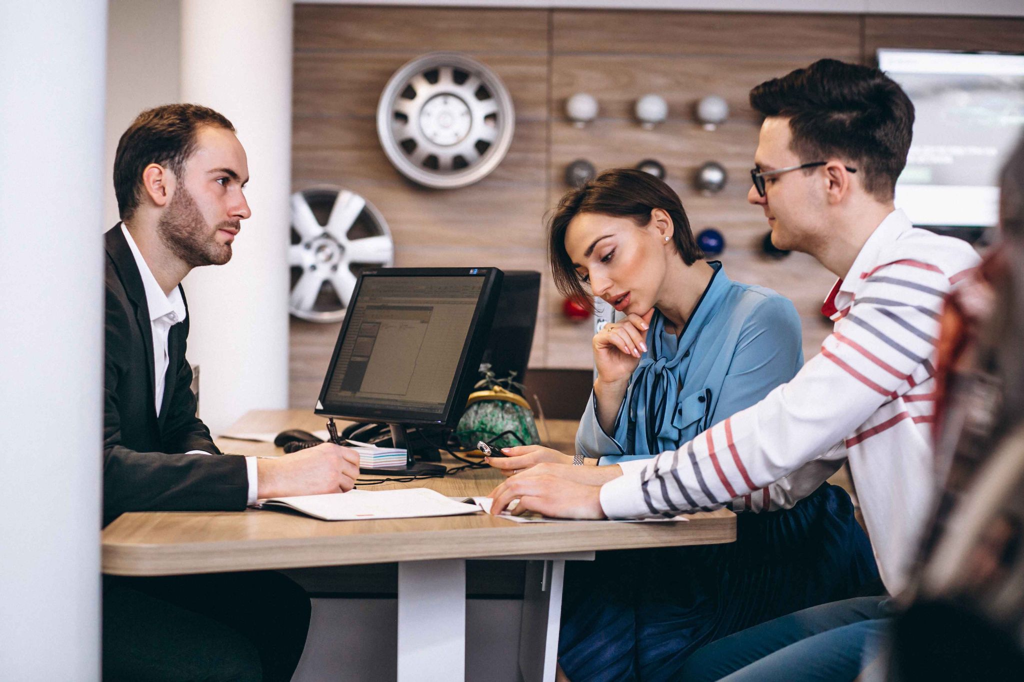 Employees and customers at a desk