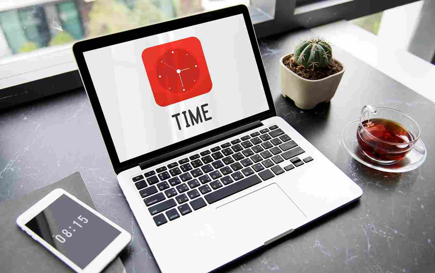 Laptop showing TIME with a clock icon and a mobile phone
