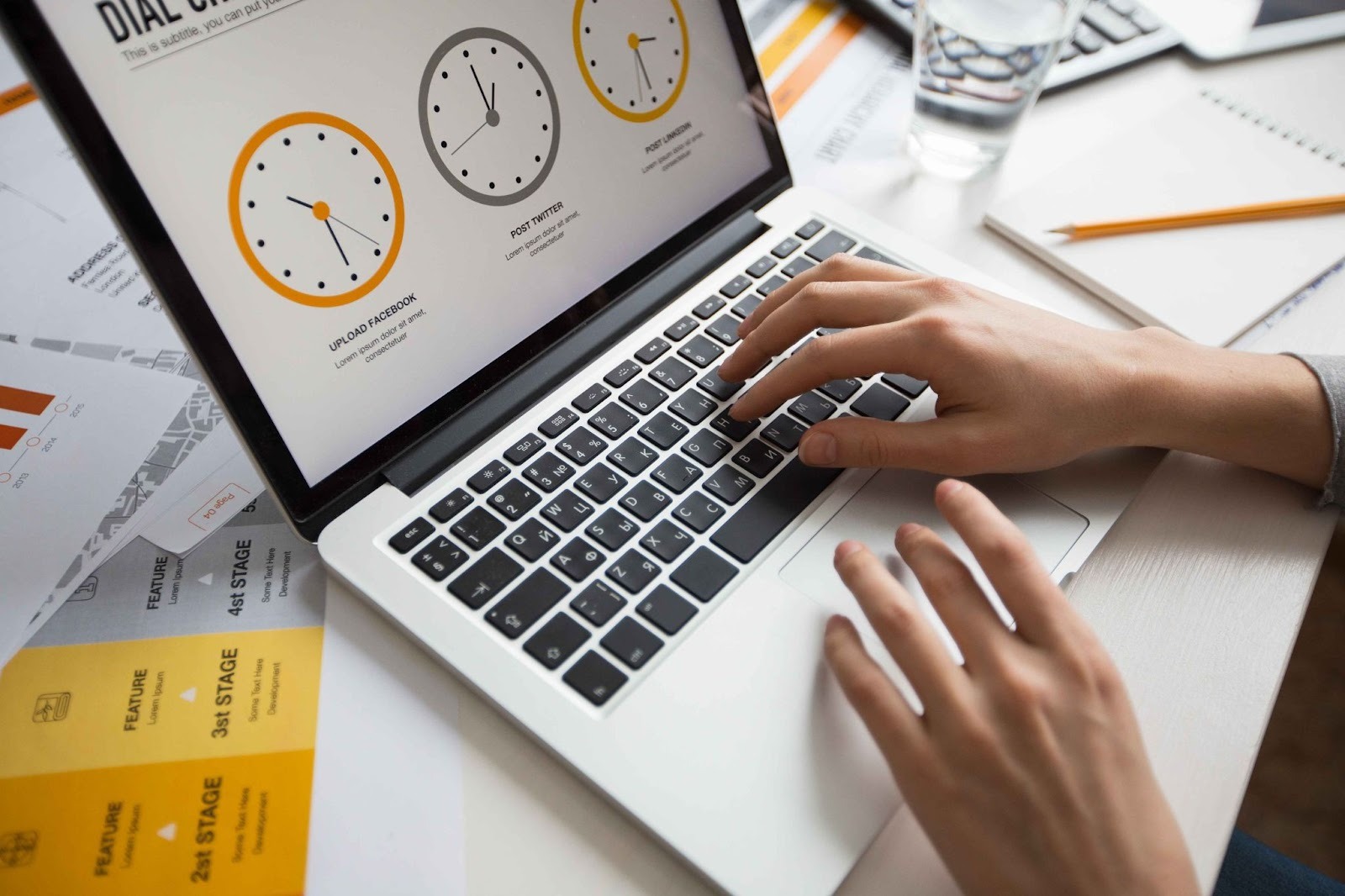 Person using laptop with time clock graphics