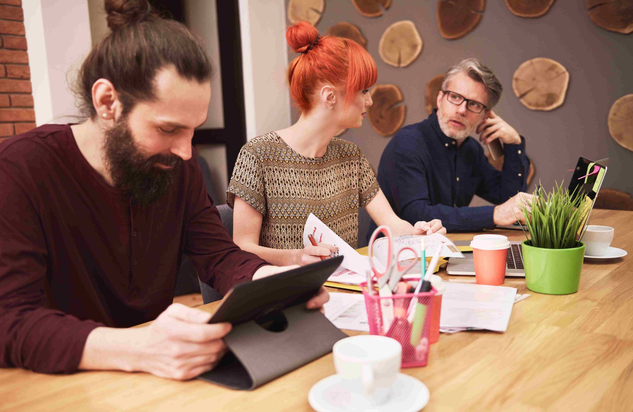 Three people working at a desk
