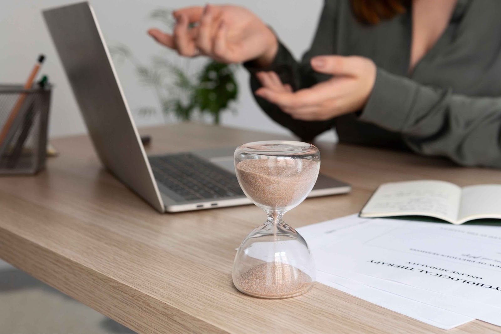 Hourglass and laptop representing time tracking
