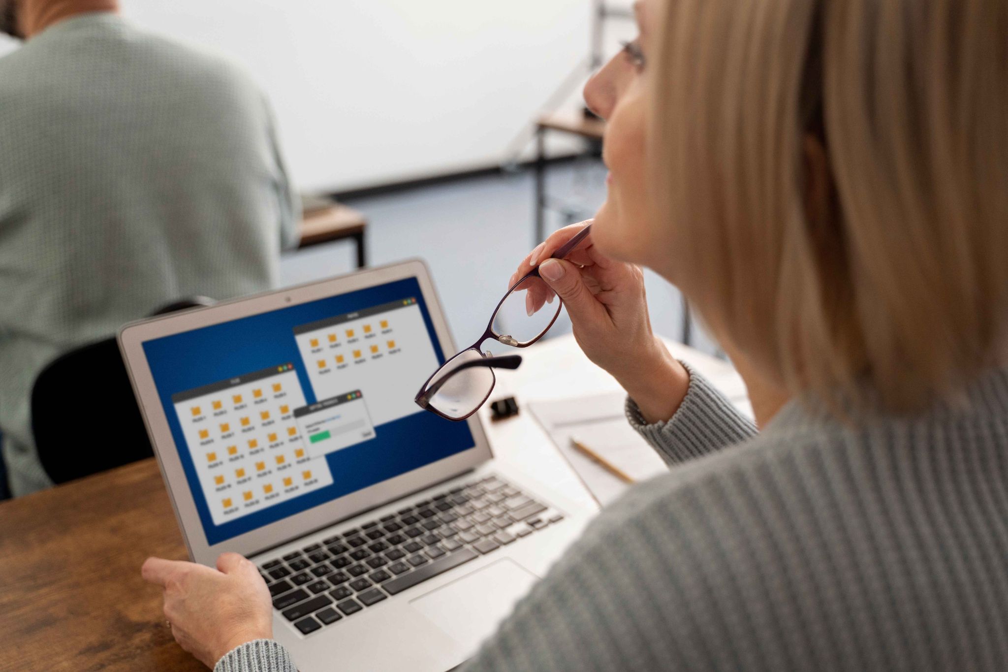Woman reviewing automated payroll processing on laptop
