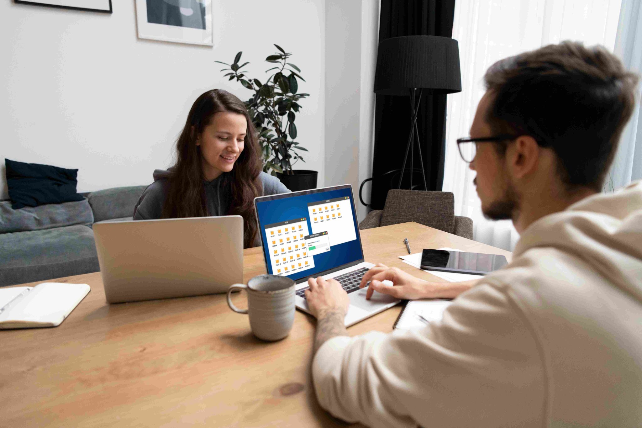 People reviewing employee timesheets on a laptop